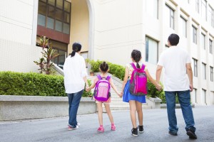 Father and mother Walking To School With Children