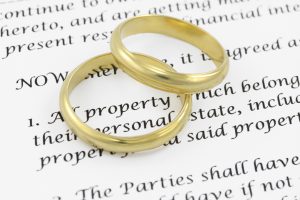 Two wedding rings on prenuptial agreement.