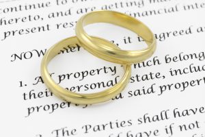 Two wedding rings on prenuptial agreement. 