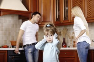 The girl in the foreground at quarrel of parents