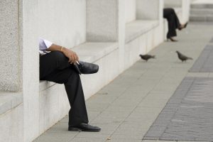 Man and woman sitting separated at court house.